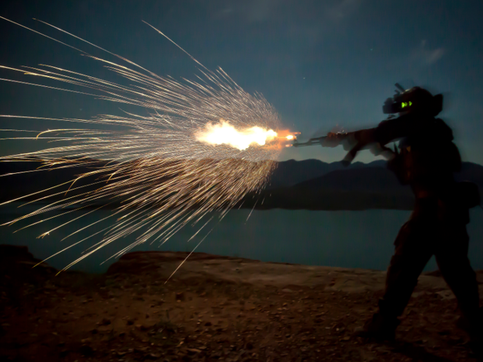 A Marine Special Operations Team member fires an AK-47 during night fire sustainment training in Helmand province, Afghanistan.