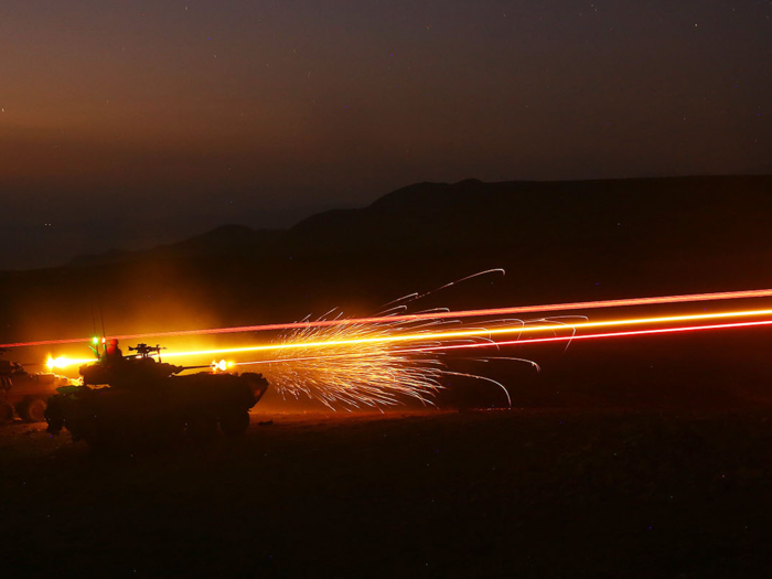 LAV-25 Light Armored Vehicles from Charlie Company, 1st Light Armored Reconnaissance detachment, Battalion Landing Team 2nd Battalion, 1st Marines, 11th Marine Expeditionary Unit (MEU), fire on fixed targets as part of a combined arms engagement range during sustainment training in D