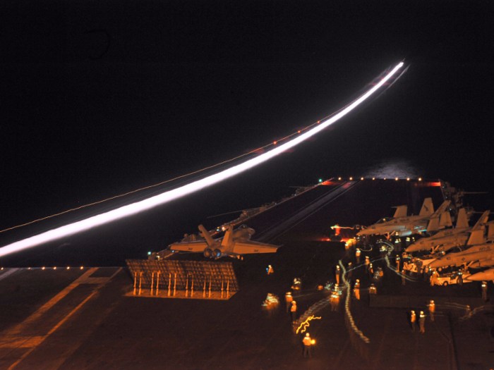 An F/A-18E Super Hornet assigned to the Knighthawks of Strike Fighter Squadron (VFA) 136 prepares to launch from catapult two during night flight operations aboard the aircraft carrier USS Enterprise.