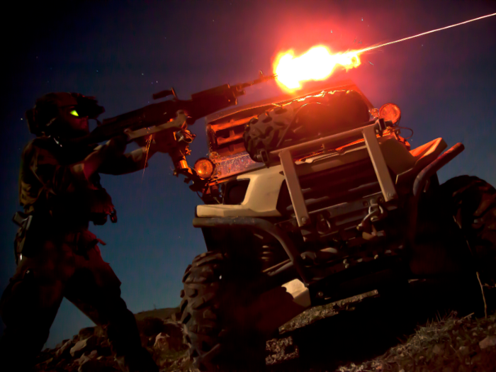 A Marine Special Operations Team member fires a M240B machine gun during night fire sustainment training in Helmand province, Afghanistan.