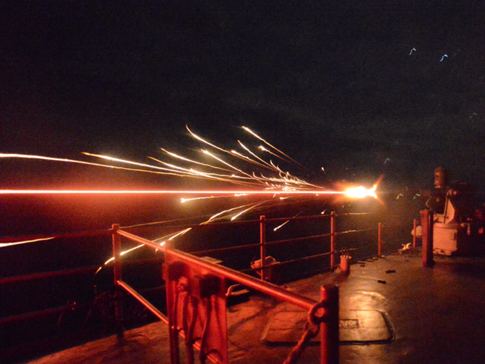 A 25 mm machine gun fires during a live fire exercise aboard the amphibious dock landing ship USS Carter Hall.