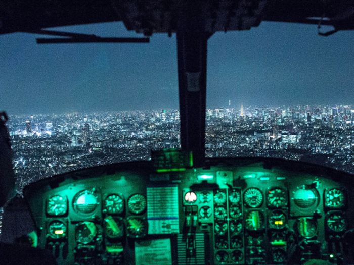 Capt. Jonathan Bonilla and 1st Lt. Vicente Vasquez, 459th Airlift Squadron UH-1N Huey pilots, fly over Tokyo after completing night training.