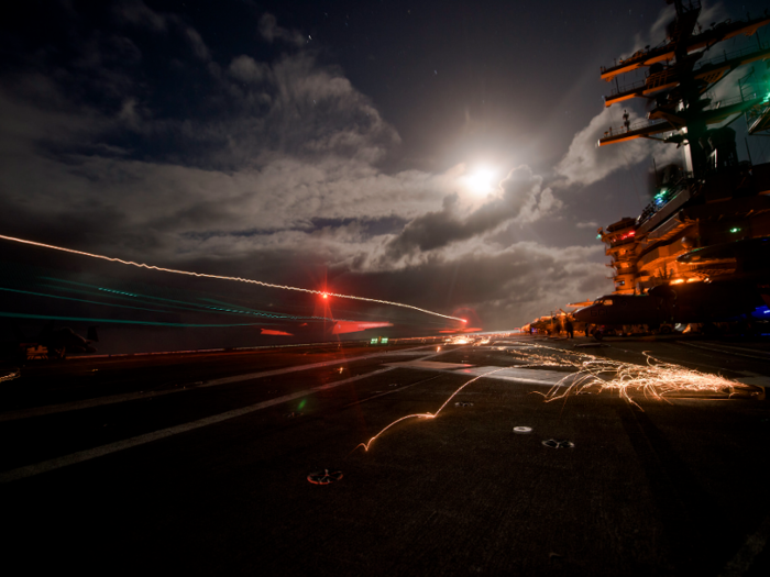 An F/A-18F Super Hornet assigned to the Swordsmen of Strike Fighter Squadron (VFA) 32 lands on the flight deck of the aircraft carrier USS Dwight D. Eisenhower.