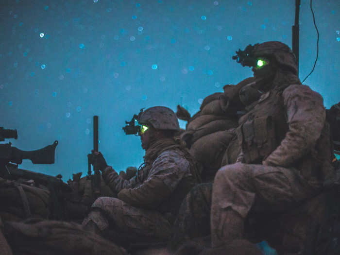 US Marines with Task Force Southwest (TFSW) observe their surroundings while at a security post for an advising mission with 1st Brigade, Afghan National Army (ANA) 215th Corps as they conduct Operation Maiwand 12 at Camp Shorserack, Afghanistan.