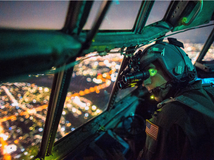 Capt. Thomas Bernard, a 36th Airlift Squadron C-130 Hercules pilot, performs a visual confirmation with night vision goggles during a training mission over the Kanto Plain, Japan.