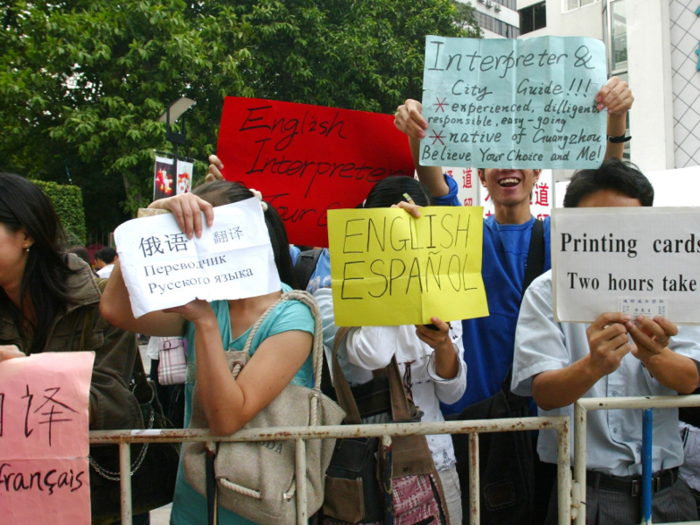 Outside the exhibition, amateur translators and interpreters offer their services.