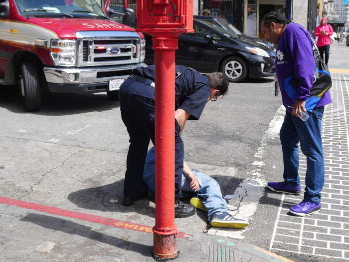 An ambulance that happened to be passing by pulled over and loaded the man, now awake and swatting away the emergency medical technicians, into the vehicle. Dudley continued down the sidewalk.