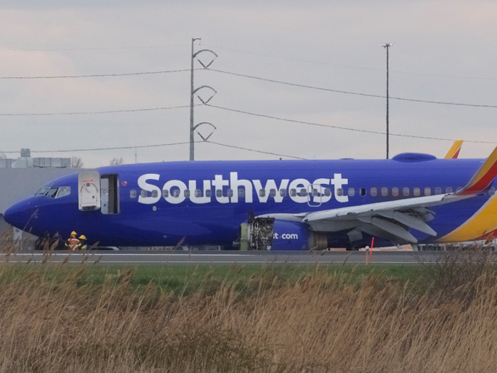 Passengers exit the aircraft via airstairs and are transported to the terminal.