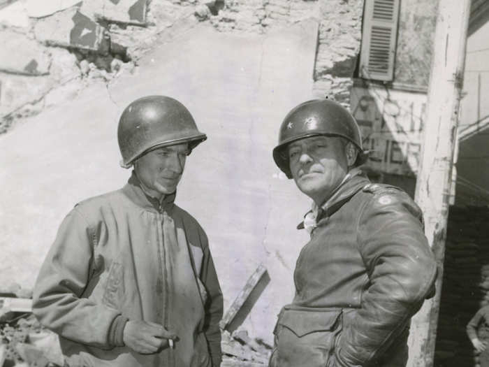 Pyle and Major General Lucian Truscott standing in front of Corps Headquarters in Nettuno, Italy, on March 26, 1944.