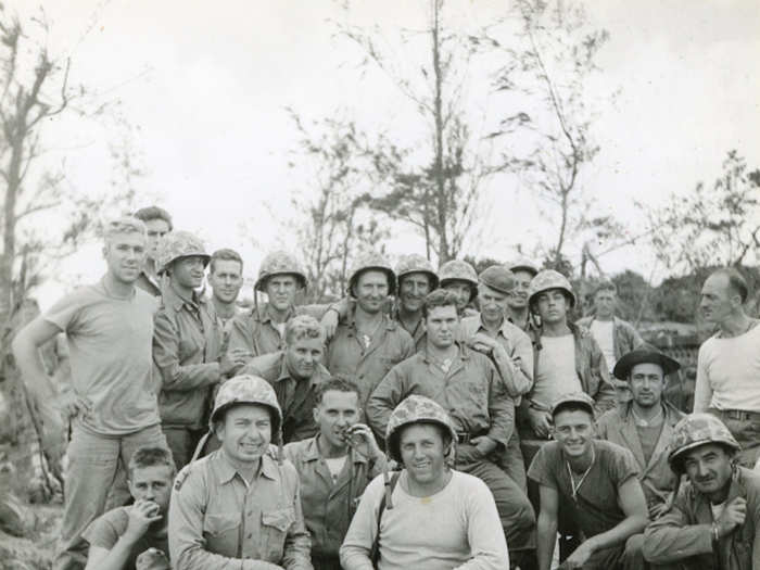 Pyle seen below in the center, leaning on a Marine’s shoulder.