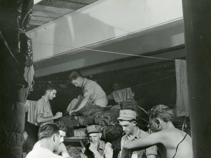 Pyle watching Marine play Casino aboard USS Charles Carroll while en route to Okinawa on March 29, 1945.