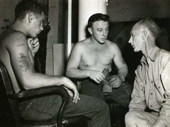 Pyle interviewing Joe J. Ray S1/c and Charles W. Page S1/C on board the USS Yorktown on February 5, 1945.