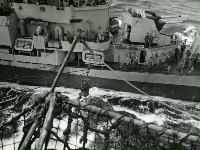 Pyle being transferred by breeches buoy from the USS Cabot to the USS Moale on February 23, 1945.