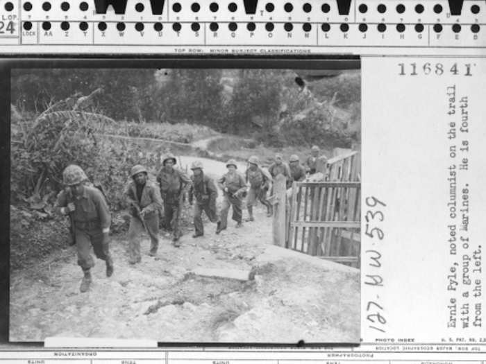 Pyle, fourth from the left, on the trail with a group of Marines on April 8, 1945.