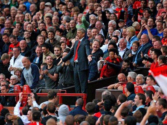 The sight of Wenger gesturing with his hands in the Manchester United stands was one of the most iconic football images of 2009. Wenger was sent away from the dugout because he kicked a plastic water bottle on the touchline. His side lost 2-1.