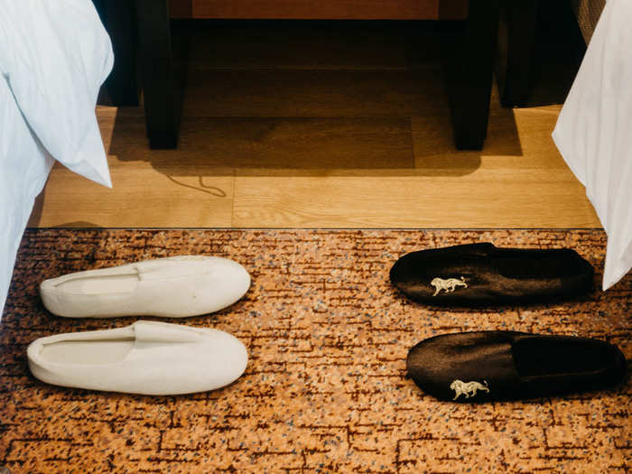 Turndown service had already arrived and dropped matching slippers next to the bed.