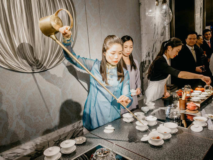 At the reception, a tea artist was performing tea ceremonies with this traditional long pot. She was deft with the pot, moving through rows of cups in seconds.