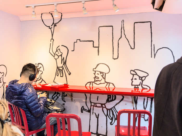 The walls have line drawings of New Yorkers at work and play, and the tables and chairs are unfussy red metal affairs.