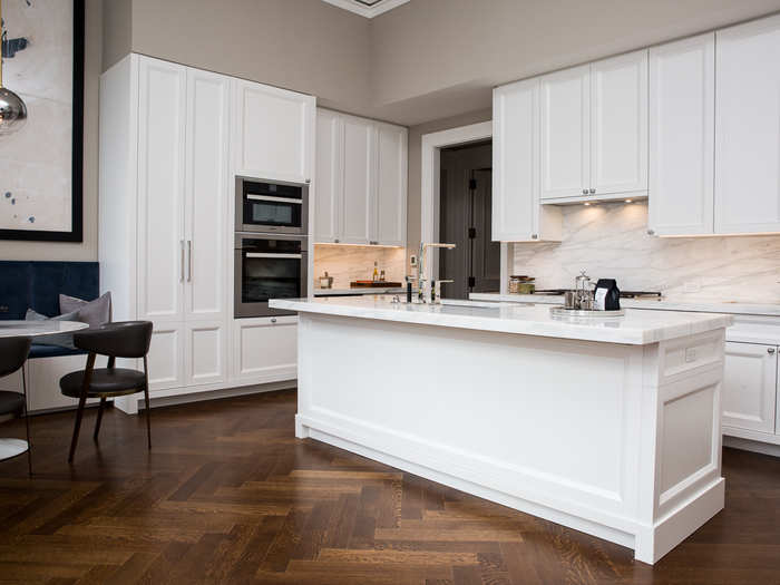 The kitchen is decked out in cabinetry crafted by the Molteni Group. Calacatta caldia marble countertops and backsplashes keep the kitchen light and airy.