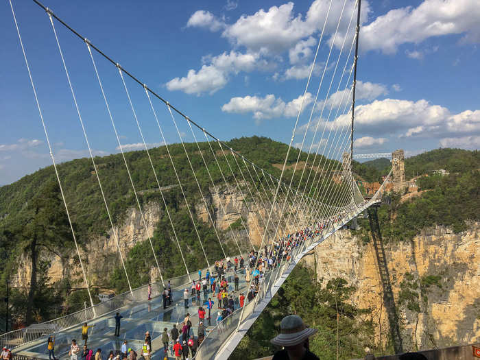 Once you have your booties, you walk up stairs into a kind of amphitheater looking out onto the bridge. Admittedly, the bridge is pretty spectacular. It was designed by Israeli architect Haim Dotan and Chinese engineer Zhi Dong Cheng.