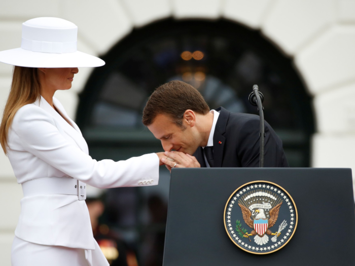 Macron greeted Melania with a kiss on the hand.