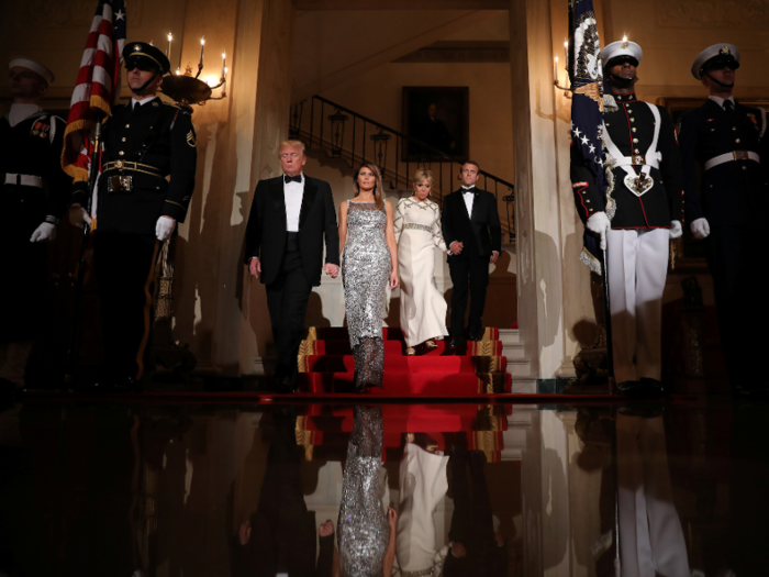 The Trumps and the Macrons make their entrance.