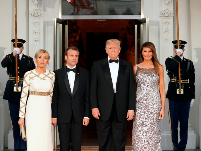 The Trumps and the Macrons pose for a photo before the festivities begin.