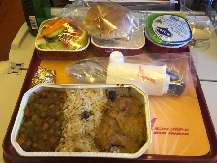 About an hour into the flight, the first round of food came out. It was typical Indian fare, some mixed vegetables and chicken curry with rice. The food wasn