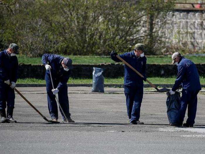 Outside, workers sweep radioactive dust at a nuclear power plant in Chernobyl.