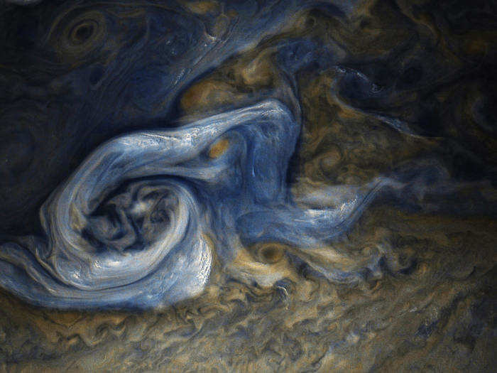 Interpretive color processing of JunoCam data sometimes makes its storms take on striking blue colors.