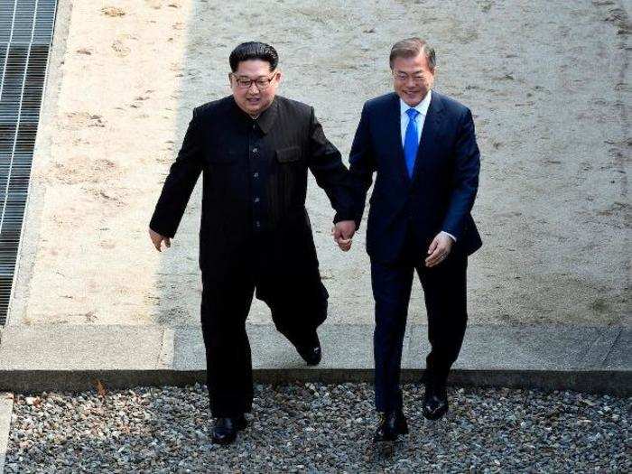 Kim Jong Un and Moon Jae-In symbolically walk across the demarcation line together before the summit.
