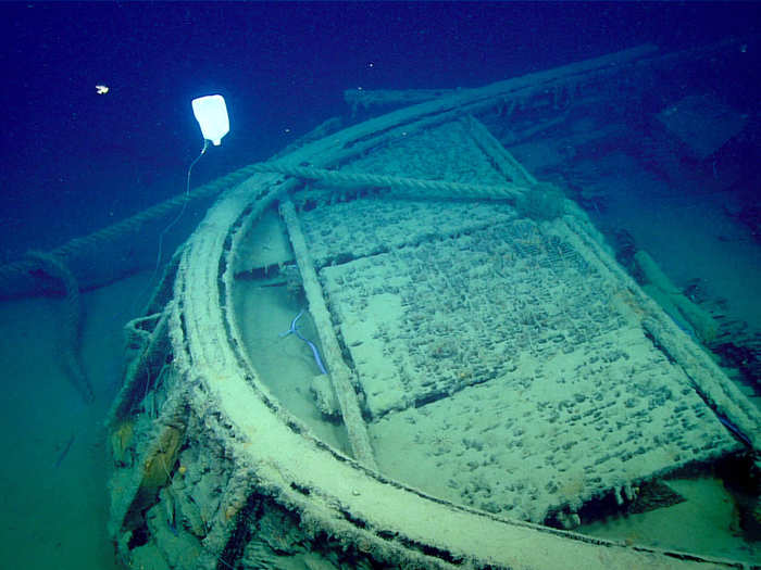 As the scientists were exploring the tug, they were perplexed by a bright white object hanging around the bow. It turned out to be a piece of trash. Even thousands of feet below the sea, humans still have an impact.