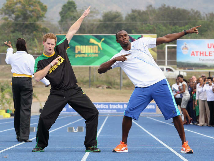 AGE 27: Prince Harry poses with Usain Bolt on March 6, 2012 in Kingston, Jamaica.