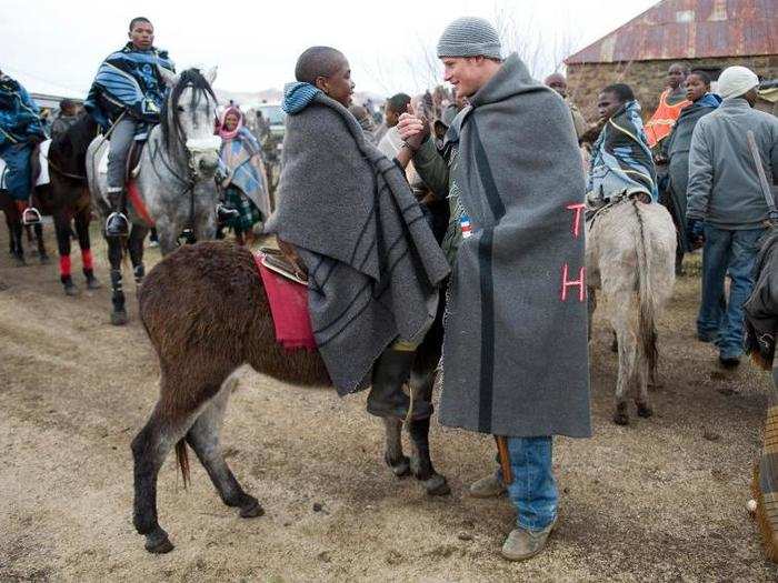 AGE 25: Harry greets a herd boy as he visits the Herd Boys School on June 16, 2010 in Semongkong, Lesotho.