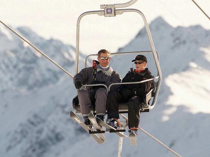 AGE 14: Prince Charles and Harry sit on a chair-lift in the Swiss resort of Klosters in January 1999.