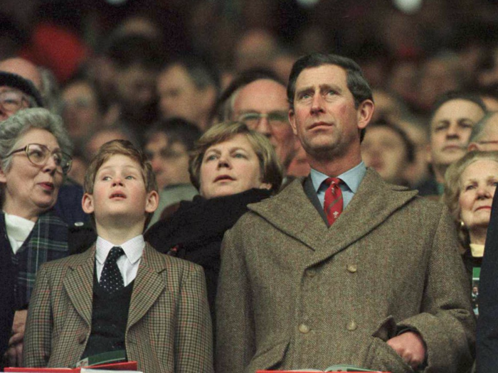 AGE 11: On February 17, 1996, Harry joins his father for the anthems during the Wales v Scotland game in the Five Nation Championship at Cardiff Arms Park in Cardiff, Wales. Charles and Diana divorced this year.