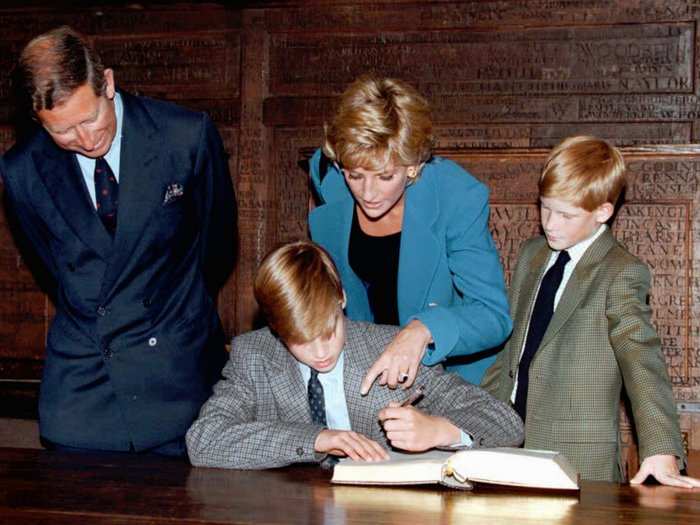 AGE 10: Harry looks on as Prince William signs the traditional entrance book at Eton College on his first day of school on September 6, 1995.