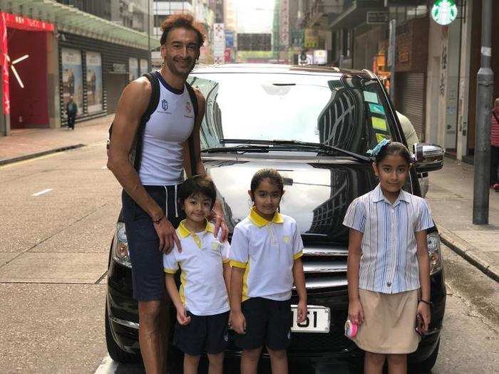 After his workout, he drives his three kids to school.