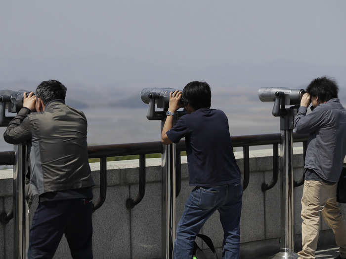 Visitors from the unification observatory in Paju, South Korea, use binoculars to peek into North Korea, April 28, 2018.