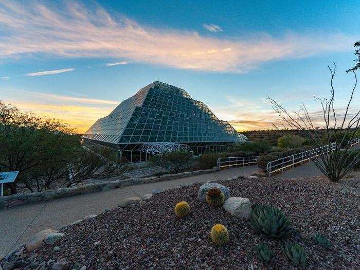 A roughly 80-foot-tall glass pyramid poking out of the hillside greets visitors.