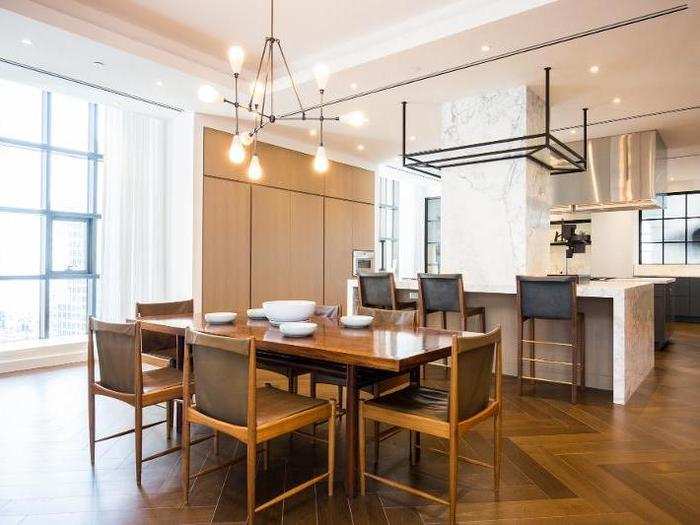 The kitchen has Calacatta Gold marble countertops and the dining area also has ample light.