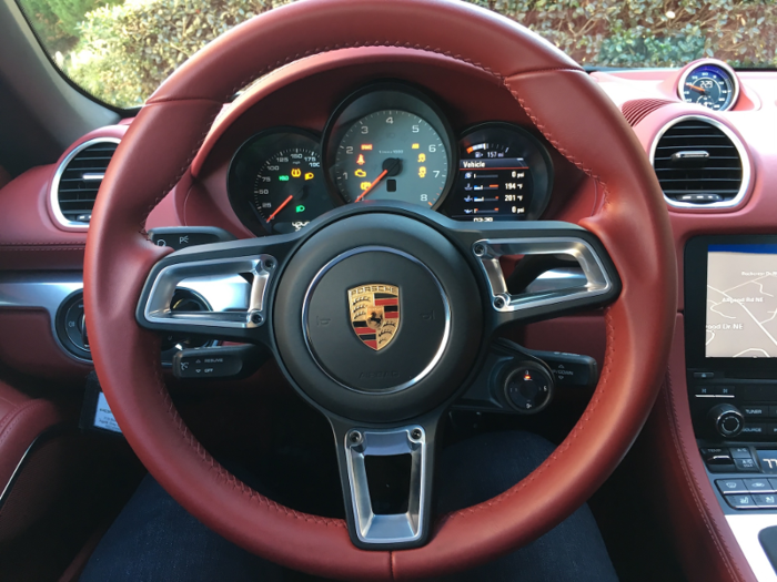 In front of the driver is an old-fashioned analog gauge cluster. As with all Porsche, the tachometer is front and center.