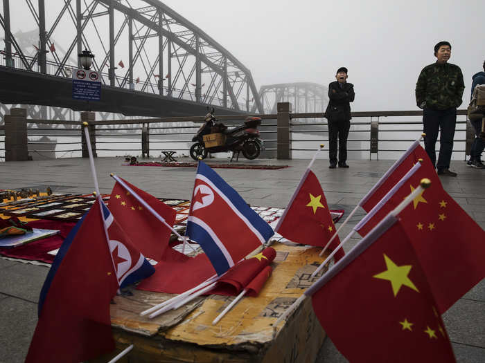 Some Dandong locals have also set up stalls by the Yalu River boardwalk, where people can buy souvenirs. They range from Chinese and North Korean flags...