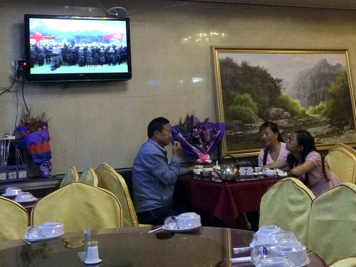 Dandong is also home to quite a large ethnic Korean population, who have opened restaurants serving North Korean food. This one in Dandong is playing a North Korean propaganda programme as Chinese customers enjoy their meal.