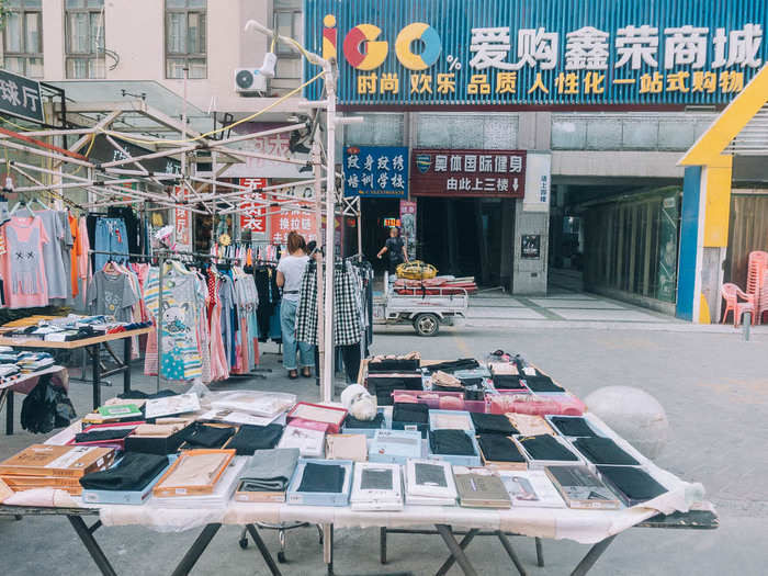 Just a few hours later, the town had sprung to life. There were street vendors selling socks, smartphone cases, and clothes, as well as mobile phone companies and banks offering services to workers getting off shift.