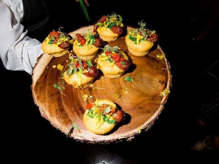 Hot dogs doused in relish, pickled pepper, and mustard were served inside cornbread muffin-buns.