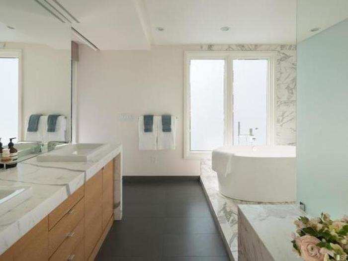 ...which also includes an inviting marble tub.