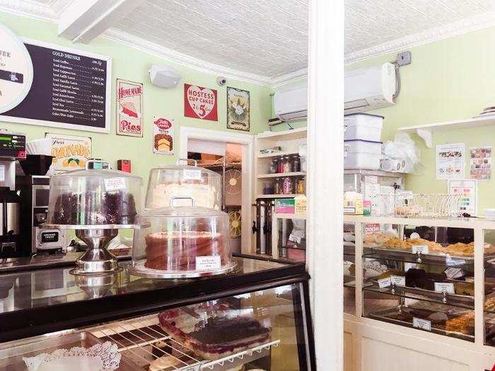 Vintage signs and jars of sprinkles and other toppings are scattered throughout the quaint bakery.