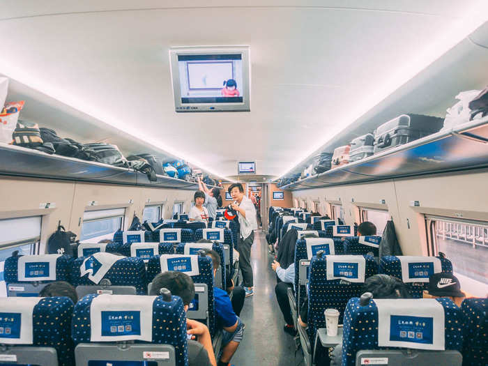 The second-class cabin looks more or less like an airplane. One side has three seats across and the other has two. The overhead compartments can handle suitcases somewhat larger than airplane carry-on size, but there is a closet at the end of the carriage for larger items. I did see a train attendant tell one passenger to take their bag down because it was too big.