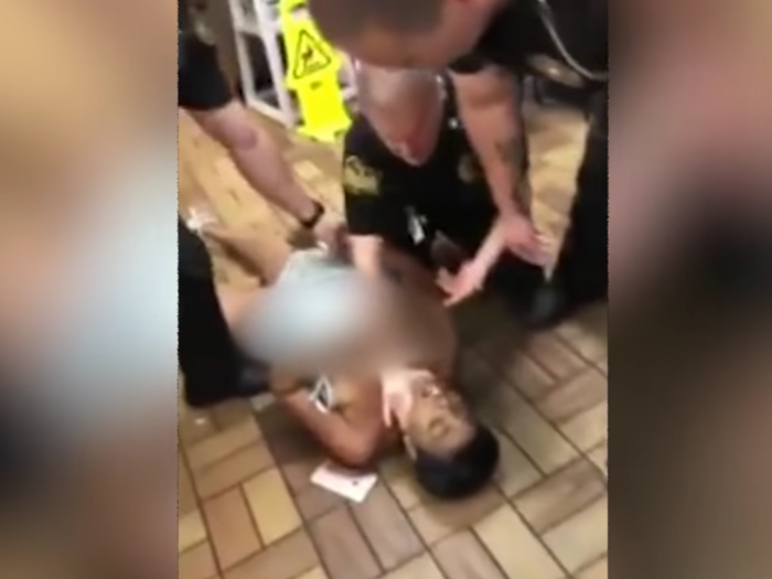 Woman forced to the ground, exposing her breasts, at Waffle House